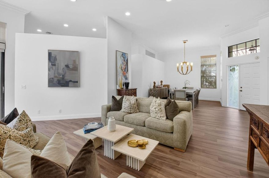 Located in the prestigious village of Oak Run within Broken Sound Country Club, this exceptional one-story residence offers over 2,500 square feet of light-filled living space with soaring ceilings, smooth walls, and a desirable split-bedroom floor plan.  The spacious primary suite features an updated ensuite bath with a frameless glass shower door and a large walk-in closet. Two additional bedrooms plus a den provide flexible living for guests, home office, or family use.  Enjoy seamless indoor-outdoor living with a covered, screened-in patio overlooking a large private backyard and sparkling pool—perfect for relaxing or entertaining. Impact windows and doors or accordion shutters throughout, along with a full-house generator, offer comfort, convenience, and peace of mind.  A rare opportunity to own a beautifully appointed home in one of Broken Sound's most sought-after communities.