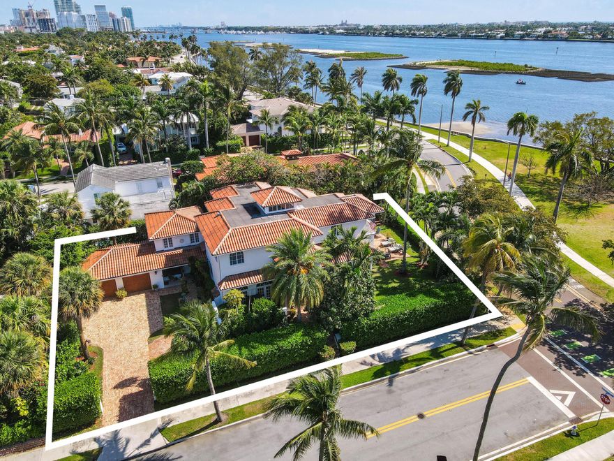 Elegant Waterfront Living in Historic El Cid. Experience timeless sophistication and breathtaking Intracoastal views from this newly renovated Mediterranean-style estate, ideally positioned on an elevated corner lot in one of West Palm Beach's most coveted neighborhoods. Built in 2002 and newly updated, this grand residence captures the essence of luxury coastal living. Set on over 10,000 square feet of exquisitely landscaped grounds, the 5-bedroom, 5-bath home showcases an open-concept layout with soaring ceilings and impact glass, framing stunning water views from the kitchen, living room, and primary suite. Designed for effortless indoor-outdoor living, the property features a heated pool, waterfall spa, and multiple covered loggias surrounded by lush tropical landscaping, perfect for entertaining or quiet relaxation. Additional highlights include a separate two-story guest house, air-conditioned two-car garage, new HVAC systems, whole-house generator, and fresh exterior paint. Nestled in the historic El Cid neighborhood, this elegant estate offers serenity and sophistication, just minutes from the beaches, fine dining, and world-class shopping of Palm Beach Island, including the iconic Worth Avenue. A rare opportunity to own a private, waterfront retreat in one of South Florida's premier locations.