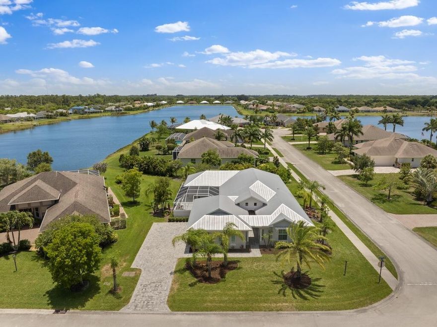 Welcome to 109 Yearling Trail, a custom home just 5 minutes from the beach. This luxurious residence features a Viking stove top, Viking steam oven, & GE Profile refrigerator and oven. It boasts a guest suite w/ a private entrance & en suite bathrooms for every bedroom, ensuring comfort & privacy. Enjoy luxury vinyl plank flooring, custom cabinetry, quartz countertops, & exquisite woodworking on all walls & trim. Brizo plumbing fixtures & Toto toilets add sophistication in every bathroom, w/ a Toto washlet in the master. Plus, indulge in the luxury of dual master closets.  Relax & unwind in the beautiful heated pool year round. Located in a gated community w/ impact windows, a 3-car garage, & stunning lake views, this home offers unparalleled luxury & convenience.