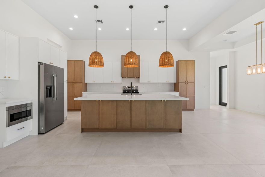 NEW CUSTOM CONSTRUCTION Waterfront with Ocean Access! Welcome to this 2025-built 4-bedroom, 3-bath home offering over 2,400 sq ft of modern coastal living near Port St. Lucie's upcoming Port District without an HOA. This residence features an open-concept layout, designer kitchen, 14 ft tray ceilings, and spacious great room filled with natural light. The primary suite includes a spa-inspired bath and private backyard access. Enjoy a covered patio overlooking your private dock with ocean access, ideal for boating and relaxation. Conveniently located near dining, recreation, and major roadways. Notable features include impact windows and doors, 48 x 48 porcelain tile throughout, 8 foot doors, 2 tone solid wood custom cabinetry, cabana bathroom, dock, automatic sprinklers, and more.