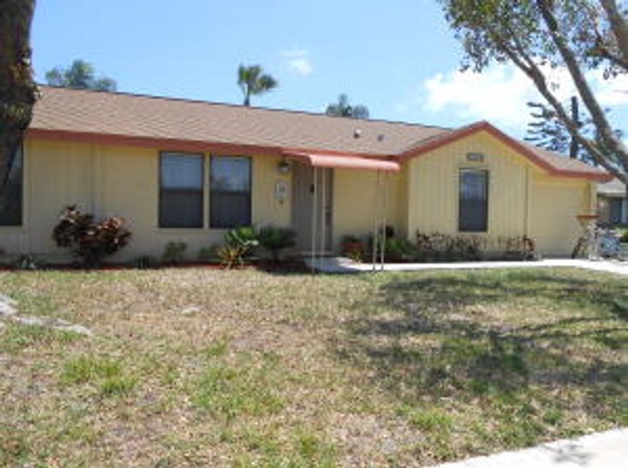 Move-in condition, shows like a model, huge back yard, room for a pool. Your family will love this home. New Roof, patio roof and screen in 2006. Newer appliances. Tiles in living area and second bedroom has gorgeous wood floors. Owner pays $2,600/year for insurance, this includes separate cover for the screened patio. Seller would like to remove wood house in back yard. Association fee is $135 2x per year.