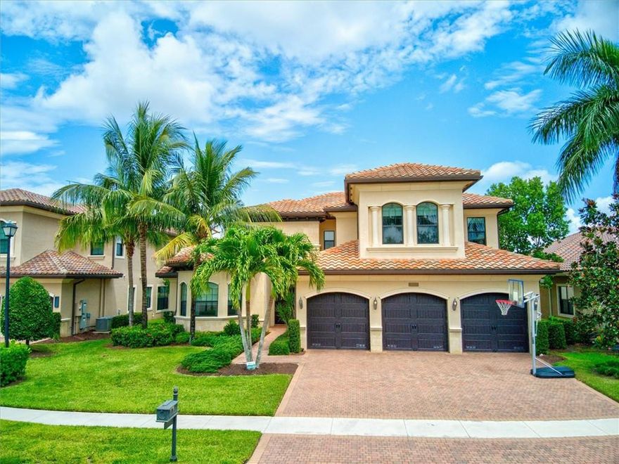 Luxurious open 2 story Bassano Model home in exclusive gated community.  5 bedroom and 7 1/2 bathrooms on an expansive and beautiful private waterfront lot with large pool. Master bedroom located upstairs with its own private balcony. Master also features beautiful trayed ceilings, his/her bathrooms, AND his/her custom closets. Also upstairs, 2 additional bedrooms, loft, and office nook. Gourmet custom kitchen with custom wood ceiling, stainless steel appliances, double door refrigerator, granite counter tops, large island and elegant custom cabinets with undermount lighting. Beautiful family room with large sliding doors lead to an amazing oversized pool and water front view. Laundry room with custom cabinets, 3 car garage and impact windows throughout complete this beautiful home!