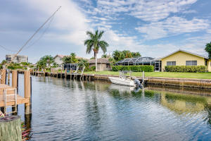 Deepwater 3 bedroom/2 bath, 2 car garage, Incredible enclosed Atrium approximately 20 x 70, South exposure, approximately 85 feet on the water. Beautiful Mexican tile, roof and A/C approximately 2003, Electric and Water at the dock. Upgraded electrical panel and electric from the street underground to the home. *Old Septic tank left in ground side of guest bedroom since 1960.