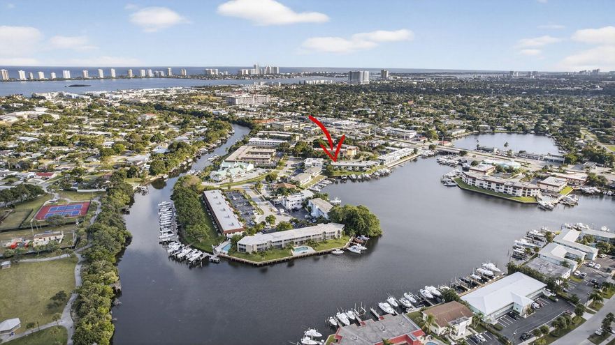 Surprisingly spacious condo with lagoon water view and private assigned boat dock with 16,000 lb lift. Updated kitchen, newer white appliances, Stacked washer, dryer in utility closet. Good size bedrooms each with a bath. Primary bedroom has walk in closet, updated bath. Lovely lanai has plexiglass windows and screens offering waterviews of serene lagoon and overlooking the boat dock. Condo roof 2 years old, fresh exterior paint, new landscaping, newly paved parking lot. Accordian shutters on windows and lanai. Dock with boat lift currently  has a 30Ft boat can hold larger. Water and electric at dock. Coveted North Palm Beach location, close to restaurants, shopping, beaches, NPB Golf course.