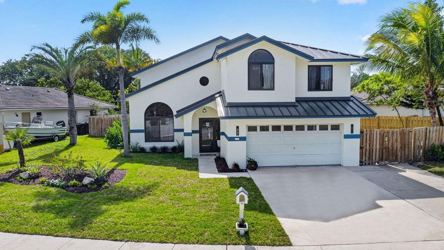 2227 Vernon Street, North Lake Worth Beach, FL - Stunning Fully Remodeled 2-Story Pool Home in Vernon Heights, is move-in ready. Features brand new roof, new impact windows, new HVAC/AC system, new luxury plank flooring, a gourmet chef's kitchen, spa-inspired bathrooms, fresh interior/exterior paint, modern lighting, and a resort-style screened-in swimming pool with spa, this turnkey 2-story single-family home offers luxury Florida living at its best.  The bright, open-concept main level is perfect for everyday living and entertaining.  Vernon Heights has a private park with boat lounge, 2 ponds, picnic area and wide streets, a true oasis! Have an RV or a Boat? Bring it on! there is room in the amazing house! Location is the key here, minutes away from the beach, stores, restaurants, The stunning updated kitchen boasts white shaker cabinets, natural stone countertops, stainless steel appliances, a large center island with seating, and designer backsplash. It flows seamlessly into the spacious living and dining areas, complete with soaring ceilings and abundant natural light from oversized arched windows. Upstairs you'll find a generous primary suite with a luxurious ensuite bathroom, plus additional spacious bedrooms and beautifully updated guest baths with modern fixtures and finishes. A convenient laundry room with side-by-side appliances conveniently located Step outside to your private screened lanai and Florida oasis: a sparkling curved swimming pool with brick detailing, integrated spa, expansive  deck, and covered seating area with ceiling fan—ideal for year-round outdoor enjoyment. The fully fenced backyard offers privacy, while the finished 2-car garage includes painted flooring . Every major system and surface has been upgraded: new roof, new windows, new AC, new kitchen, new bathrooms, new floors, and so much more. Located in the highly sought-after Vernon Heights neighborhood of Lake Worth Beach with easy access to shopping, dining, golf, parks, beaches, and the Intracoastal Waterway. This rare fully remodeled pool home in Vernon Heights, Lake Worth Beach with all the newest upgrades is loaded with modern features and ready for its next chapter. Don't miss out—schedule your private showing today!