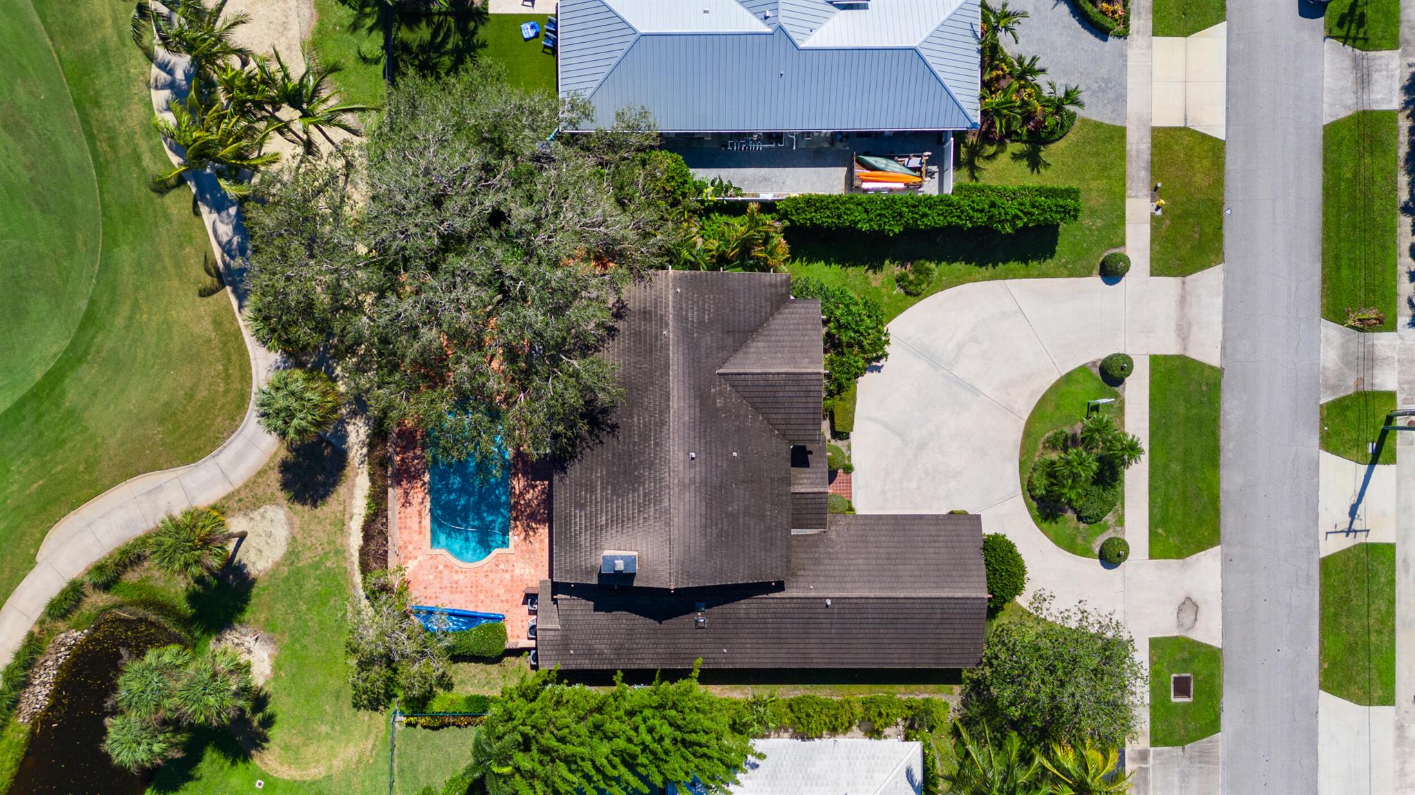 Welcome to 868 Country Club Drive - an extraordinary opportunity to own a home in one of the most coveted locations in the Village of North Palm Beach. This remarkable property, on the market for the first time ever, offers an unparalleled combination of space, location, and potential for customization. Nestled on an oversized lot of over 15,000 square feet, this residence has delightful ocean breezes and sweeping lake and golf course views, overlooking the 13th hole of the recently redesigned Jack Nicklaus Signature Golf Course. Well-kept by just one family since its inception, this sprawling home boasts a generous 6,245 total square feet, with nearly 5,000 square feet of living space, including 5 spacious bedrooms and 3.2 baths.