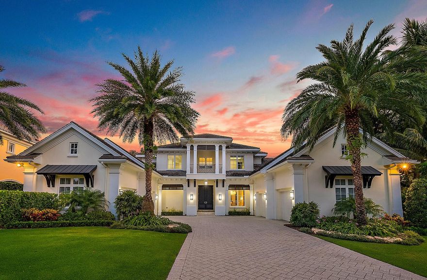 CUSTOM RESIDENCE sits on a large half-acre plus lot boasting 132' of wide Intracoastal waterfrontage, with old growth trees and new landscaping, ideal for the outdoor Florida lifestyle. Enjoy the new patio and pool w/ spa, and the all-new covered summer kitchen and grille while watching the big event on the flat screen TV. The lush green lawn slopes down to the private dock and 20,000 lb. boat lift. All this outdoor beauty is enjoyed from the first floor Primary bedroom, office, living room, and  kitchen/family room with casual breakfast area.  The home also includes a wine room, dining room, a guest bedroom that can double as a second office, laundry, dual garages for four vehicles with ample room for storage, and a large bonus room.