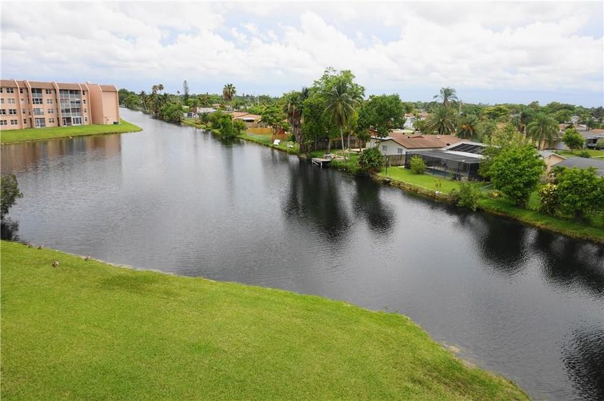 One bedroom with water views in the golf community of Sunrise Lakes.  Top floor unit has canal views from the screened in balcony and the bedroom.  Bedroom is very large with a walk in closet, bathroom has shower tub combo.  New dishwasher, new washer & dryer, AC 2012.  Appliances have Service American contract.  No renting.  Unit is just off elevator.  Sunrise Lakes is a 55+ community that offers many classes and events for its residents.  Large swimming pool, billiards, sewing room, theater and more.