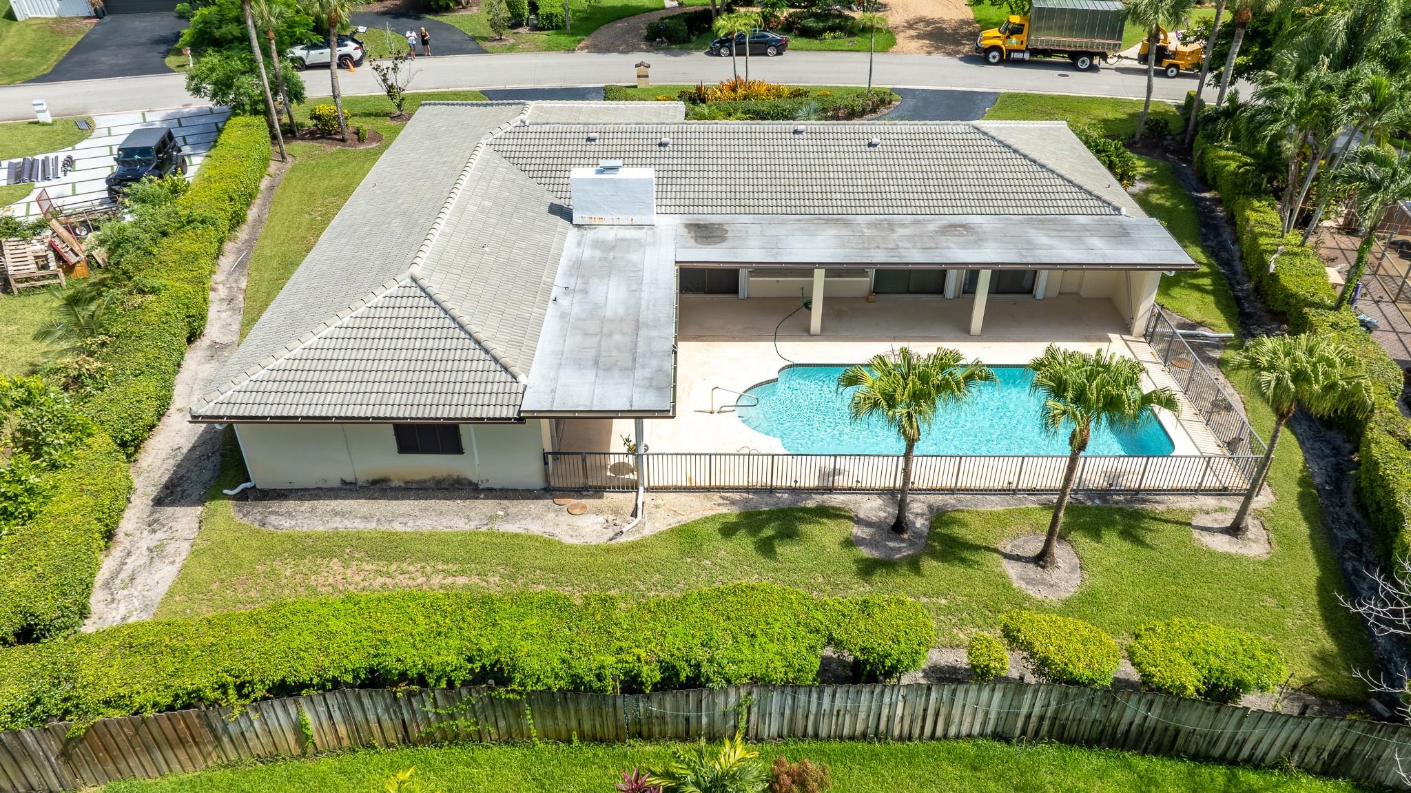 ***WOW*** A very rare opportunity nestled on a quiet street in the heart of Coral Springs with no HOA! This extremely spacious home boasts 3,460 total sqft of quality living space, perfect for entertaining including formal living room, dining room, and a large family room featuring a working fireplace!!! Great bones!! Sitting on an oversized 15,000+ sqft pie-shaped lot, enjoy the meticulously maintained outdoors + the massive pool and patio w a huge pass thru window to the enormous kitchen!! Top-rated Coral Springs school system!! 2023 roof!! New A/C!! Split bedroom floorplan! Just a short golf cart ride to the Coral Springs Country Club!! Huge utility/laundry room under A/C + an oversized garage + massive circular driveway! Two en suite bedrooms!! The list goes on...