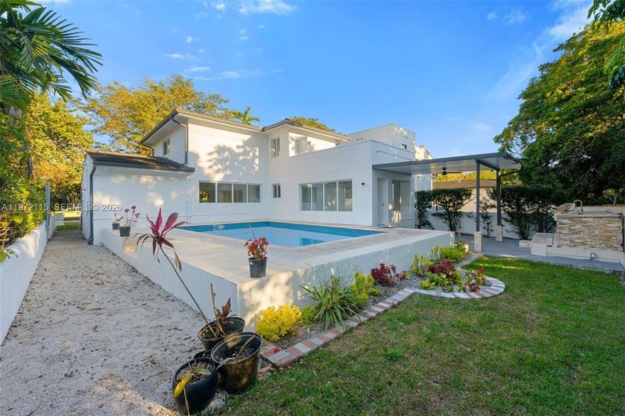 Priced to sell! Refined two-story home in North Coral Gables on a quiet, tree-lined street. Features modern finishes and waterproof rigid-core flooring throughout. Layout includes 3 bedrooms and 2 baths, plus a flexible ground-floor room ideal as a 4th bedroom, office or media space. Impact windows and doors provide abundant natural light. Upstairs offers a large private terrace, perfect for relaxing or entertaining. Backyard designed for Florida living with a 9-ft deep pool, lush landscaping, covered patio with built-in BBQ, and storage structure. Spacious driveway and updated 1-car garage. Upgrades include new roof (2022), fascia, gutters and full impact protection. Prime location near Miracle Mile, Biltmore, Granada Golf Course, UM and MIA.