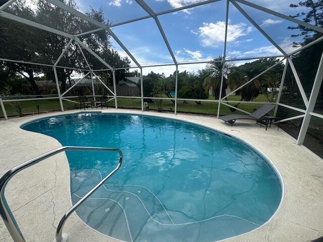 This is it! Step Inside and Fall in Love! This Cozy yet Spacious home greets you with a Bright Foyer and Sparkling Pool Views the moment you walk in. The Split Floor Plan offers privacy while the Kitchen boasts abundant cabinets for all your storage needs. Outside, enjoy a beautiful Oversized Screened Pool and Lanai, Perfect for Relaxing or Entertaining. The Newly Painted Front with Fresh Landscaping enhances it's curb appeal. This is a Centrally located, Well-established, Desirable Neighborhood! No HOA! Easy Access to Shopping/Restaurants/Turnpike/I-95, Tradition & SLWest, Schools, the Beach and More! More Updates include New lighting& Ceiling fans, New Pool Cage, New Pump & Child Gate ('23). A True Gem that blends Charm, Comfort and Outdoor Living! Call today!