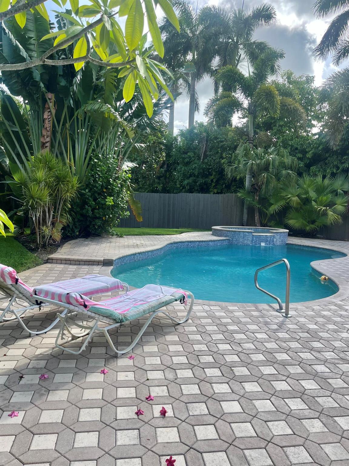 Welcome to your own private oasis! Tucked away in a peaceful and secluded setting, yet just minutes from shopping, dining, and everyday conveniences, this unique 3-bedroom, 2-bath home with a den offers the perfect blend of tranquility and accessibility.Surrounded by lush, tropical landscaping, the property feels like a personal resort. Step into the large screened Florida room - ideal for relaxing or entertaining - and enjoy the view of your sparkling pool and beautifully manicured grounds. An open patio extends your outdoor living space, The home's versatile layout includes a den that can be used as an office, guest room, or creative studio. There's ample room to park your RV or boat, a rare find !!