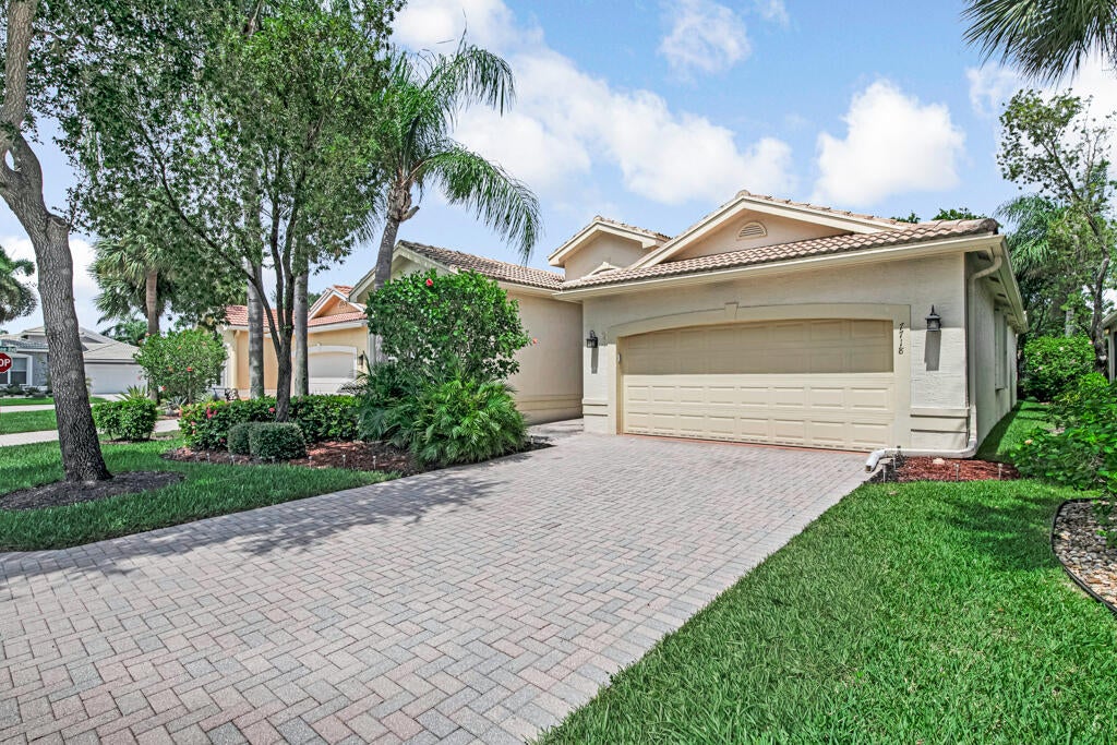 Photo of 7718 OCEAN SUNSET Drive, Lake Worth, FL 33467 (MLS # B26055497)
