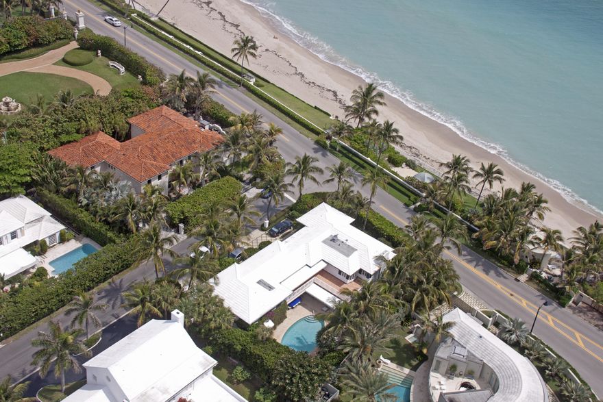 Estate Section Oceanfront! This Monterey Colonial has the perfect balance of indoor and outdoor living & entertaining with a 2-car garage. This gracious home hosts 6 bedrooms & 7 baths including a library with full bath and 2 floor guest or staff suite. High ceilings, beautiful crown detailing, oversized well equipped eat-in kitchen & family rooms overlook the 30 x 15 heated pool w/cabana bath and surrounded by well-manicured gardens. The gated & private 6,500 SF deeded beach parcel has a shower, raised decked seating/dining area. Dining room chandelier is excluded from the sale.