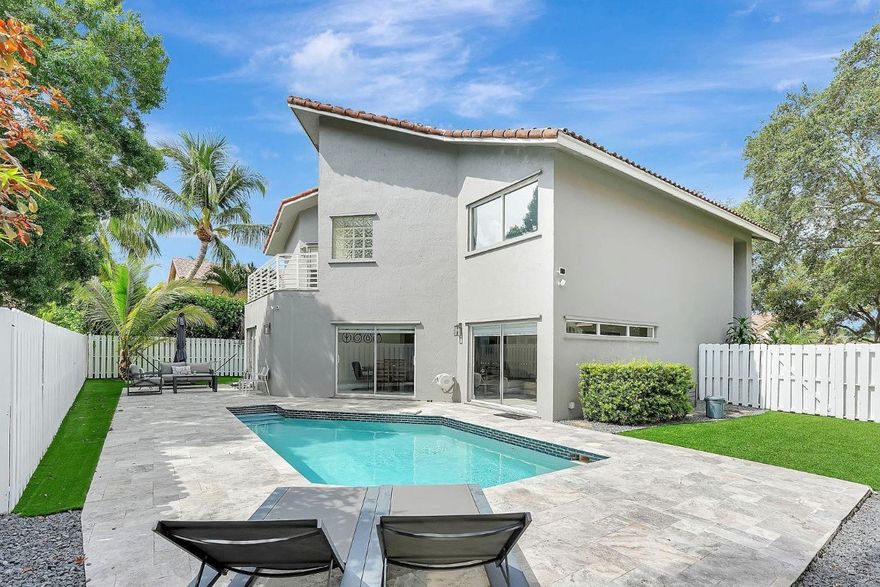 Stunning newly renovated 4 bedroom, 2.5 bath split-level pool home in highly sought-after Parkland! This beautifully updated residence showcases a sleek, modern aesthetic with clean lines throughout. Step inside to an open-concept living and dining area with soaring vaulted ceilings and high bay windows that flood the space with natural light. The family room flows seamlessly into the kitchen for effortless entertaining. Upstairs, the spacious master suite features its own private balcony overlooking the sparkling pool. Approximately 2,610 sqft under air with ample closet space. Both bathrooms offer double sinks, and the master bath includes a separate tub and shower. Zoned for Parkland's top-rated A+ schools. Prime location with easy access to major highways. A true must-see! Recent renovations include modern updates throughout with a fresh, contemporary design. Pool home perfect for Florida living. Split-level floor plan offers excellent privacy and separation of living spaces. Master balcony provides peaceful pool views. Low HOA community. Excellent investment opportunity with tenant in place generating income.