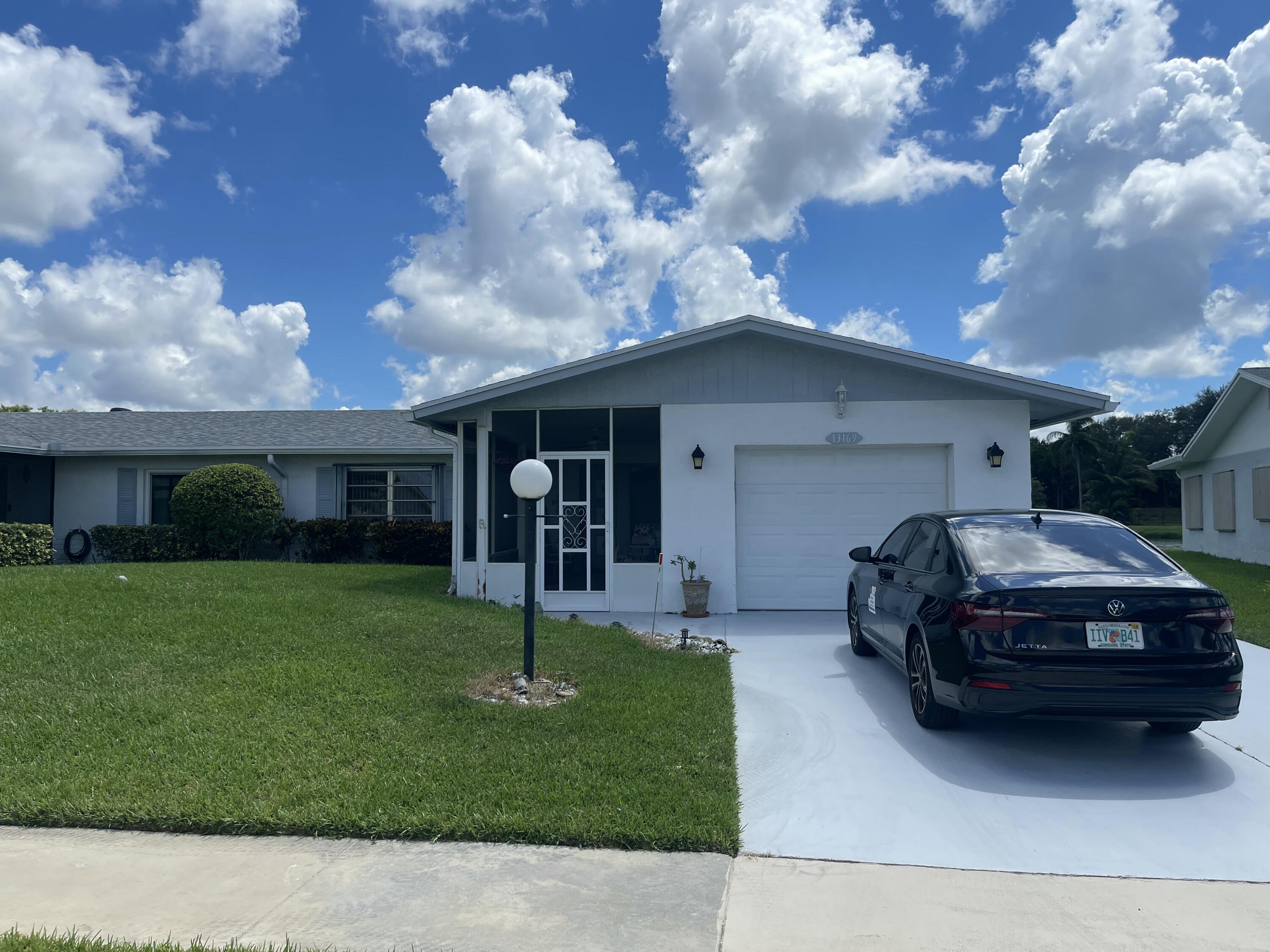 Priced to sell. this 2 bed 2 bath 1 car garage 55+ villa with a very low HOA, that incudes internet, cable and HBO. Fully enclosed under air sunroom for extra square footage. New Roof 2023 New AC, Newer Hot Water Heater, Hurricane Shutters, Lake view, Association include a large heated pool with hot tub; fully equipped gym; tennis courts; bocce court; ballroom, card, craft, and meeting rooms, and library. There is a satellite pool located in same section as home. SOLD AS IS.