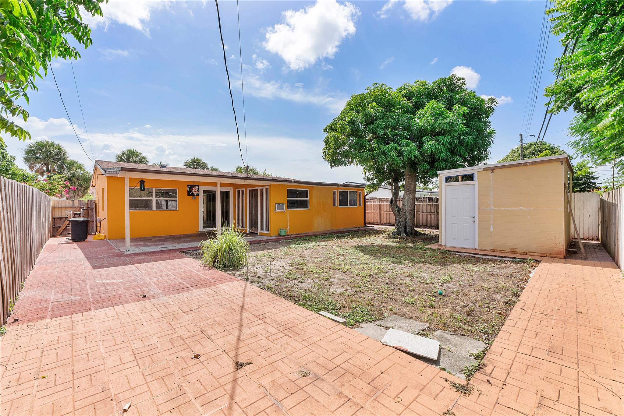 Welcome to this beautifully maintained single-family home, NO HOA in the heart of Broward County, offering 2 bedrooms, 1 bath, and 1,155 sq. ft. of living space. Recently updated with a new roof (2020), plumbing (2020), and electrical upgrades within the past 5 years, this home provides both comfort and peace of mind. The interior features tile flooring throughout, a bright and inviting layout filled with natural light, and a split A/C unit for efficient cooling. Step outside to enjoy the 140 sq. ft. covered porch, perfect for relaxing or entertaining, as well as a lush yard with a beautiful mango tree. A unique tower feature adds charm and architectural character, while a separate storage building on the property provides extra functionality.