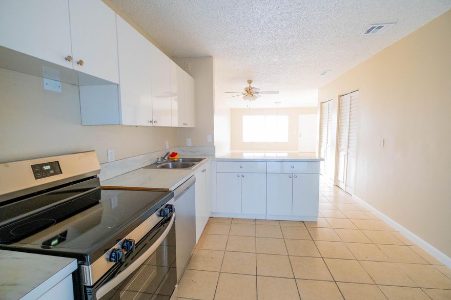 Great, beautifully maintained freshly painted 3 bedroom, 2 bath townhome offering a spacious open floor plan designed for comfortable everyday living. The family room, dining area, and kitchen flow seamlessly, creating an inviting space for both relaxing and entertaining. All Tile flooring runs throughout the entire home for durability and easy maintenance. The kitchen features ample cabinetry, solid surface countertops, and brand-new stainless steel appliances, new Washer and Dryer. Enjoy the fully freshly painted fenced backyard , perfect for outdoor living. Low HOA and prime location near shopping, dining, beaches, and major highways. Move-in ready and ideal for primary residence or  investment.