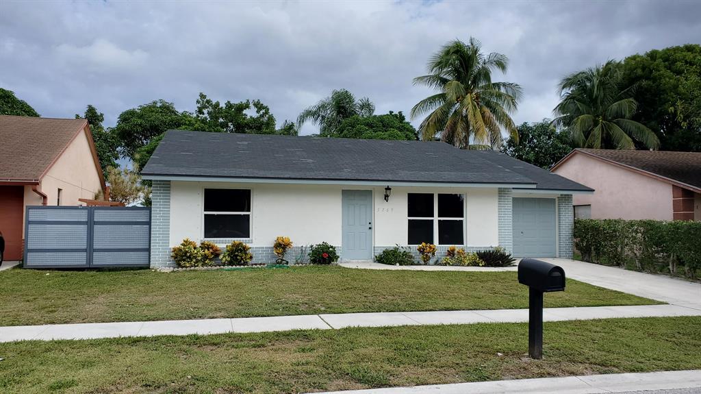 Beautifully upgraded home with a great fenced and private waterfront back yard. Black Stainless appliances, Quartz counters and white Shaker cabinets give the kitchen a clean fresh look. There are two huge pantry cabinets along side the French Door refrigerator. The main bedroom also overlooks the back yard and lake, and has a beautifully updated bathroom and custom closets. The 2nd bath is also nicely updated. There is new tile throughout the house with no carpet! There are upgraded full size washer and dryer, and an oversized one car garage with opener. There's a powered awning for shade in the back yard, and hurricane shutters for all windows. And there's Natural Gas to efficiently power your range, water heater and clothes dryer. This is a great home in a a great location.