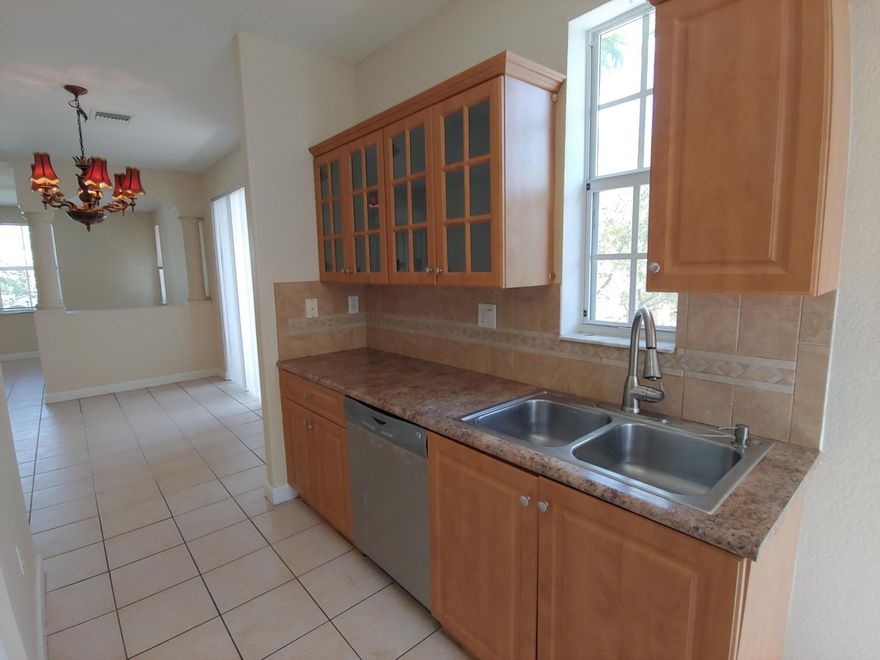 Fully renovated freshly painted move in ready townhome features all brand new stainless steel appliances, brand new laminate on stairs area, newer laminate elsewhere, wood kitchen cabinets, upgraded bathrooms vanities & finishes, etc. One bedroom with its own bathroom inside the bedroom & a walk in closet on the ground floor - can be used as a master bedroom or a spacious guest room, all other 3 bedrooms are on the 3rd level. Second floor offers all tiled living & dicing rooms, kitchen, half bathroom, a balcony. Washer & dryer are inside the garage. 1 car driveway and 1 car garage. Directly across community pool & mail boxes. Fast move in - no hoa approval required. West palm beach, Delray, Boca and Pahokee housing authorities are welcome, must hold 4 bed voucher. Pets Ok