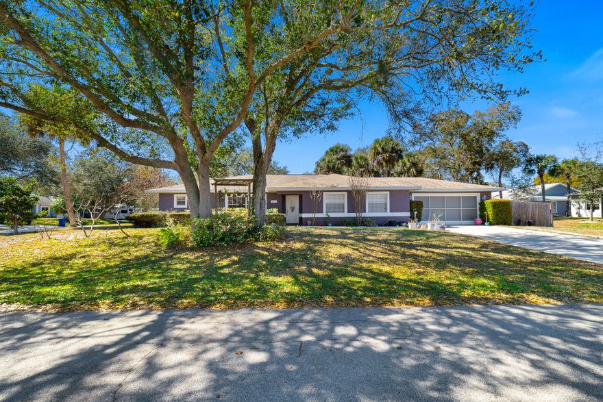 Situated on a fully fenced corner lot, this property offers added privacy, generous outdoor space, and dedicated parking for boats, trailers, or other toys securely stored behind the fence. The home is constructed of durable concrete block with a hip roof design and features updated hurricane shutters and an upgraded garage door for added peace of mind. A sprinkler system on well helps maintain the landscaping efficiently.  Inside, tile flooring extends throughout the main living areas, creating a clean and cohesive look that is both durable and easy to maintain. The open floor plan offers excellent flow, with separate living and family rooms providing flexible spaces for both entertaining and everyday living. The spacious walk-through kitchen is thoughtfully designed for functionality and convenience, featuring stainless steel appliances and ample workspace. The home offers three well-appointed bedrooms and two full bathrooms, with attractive wood-look flooring in the bedrooms for added warmth and comfort. Enjoy Florida living year-round on the large screened porch, and take advantage of the oversized two-car garage offering additional storage space. With no HOA fees or restrictions, this property provides the freedom and flexibility today's homeowners appreciate.