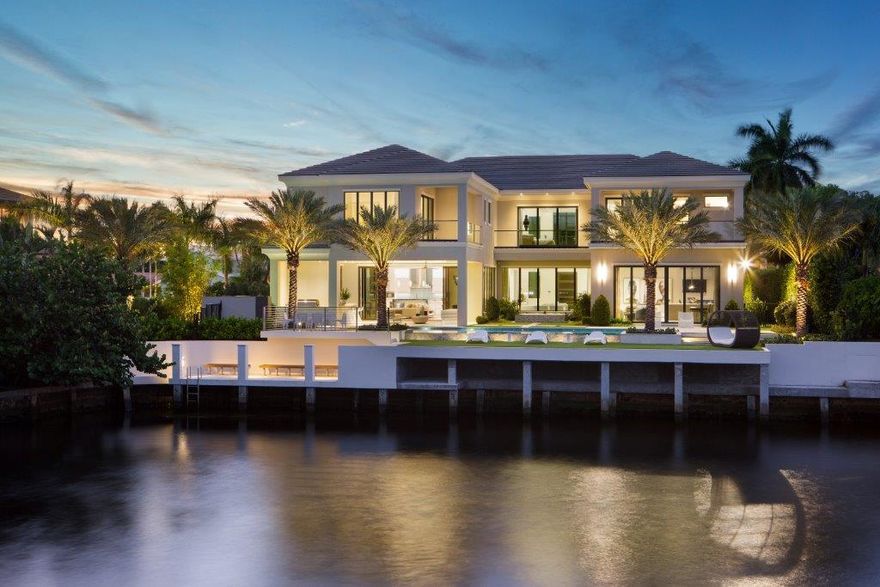 ''New'' Modern Coastal-inspired deepwater Masterpiece on Royal Palm's Grand Canal is sited on 110 +/- ft of waterfrontage by prestigious Bloomfield Development and Decorators Unlimited interior design. A striking Gallery Foyer with slab white diamond floors sets the stage for this architectural estate and with all major rooms facing the waterway. The resort-style 68+/- ft. infinity edge pool boosts a fountain feature, separate spa and lanai with professional summer kitchen and cabana for entertaining. 4 bay garage with capability of 4 car lifts for the connoisseur. Shown by appt only.