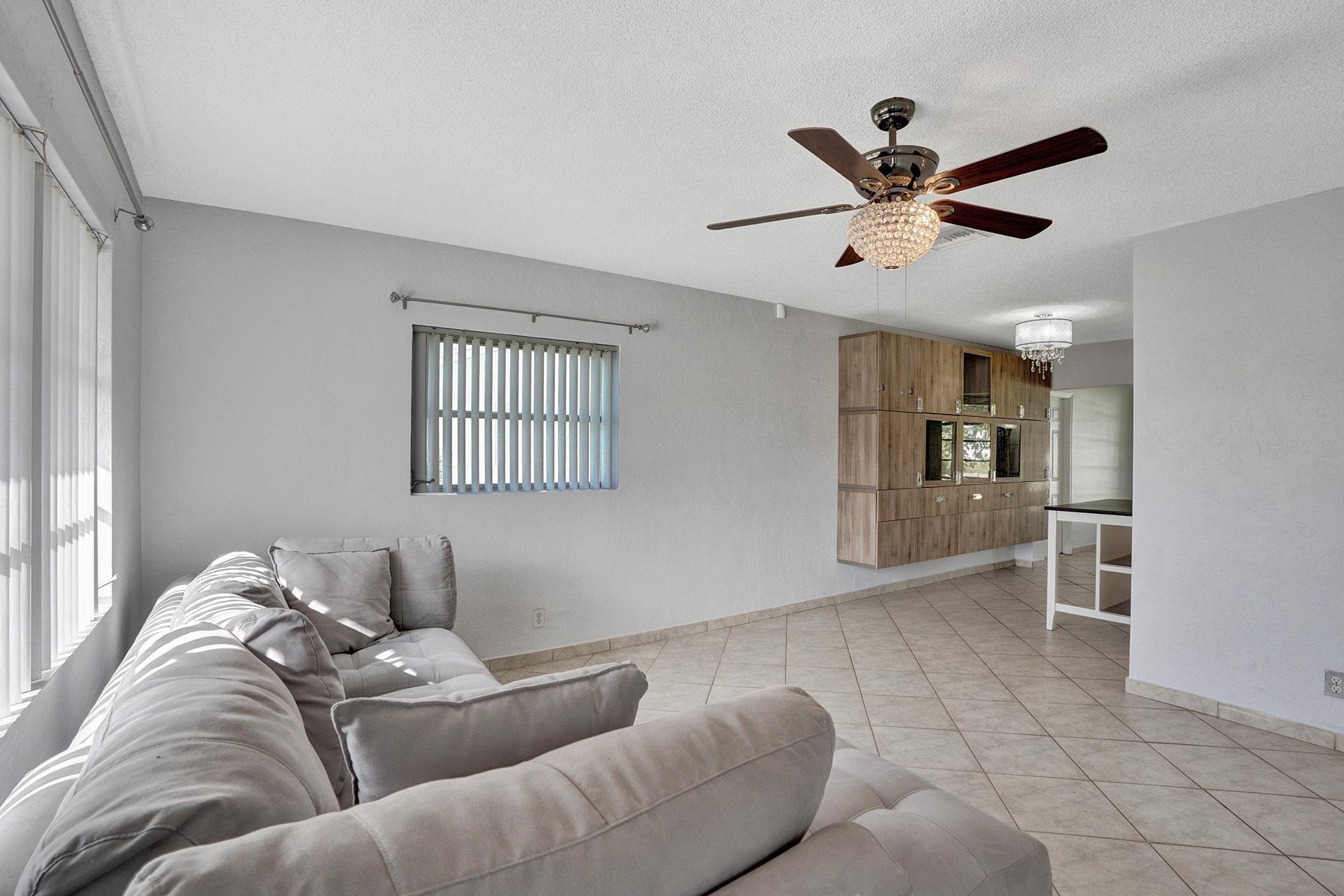 NEW ROOF BEFORE CLOSING! 55+ Community of Mainlands. Welcome to a charming single-family home nestled in the vibrant city of Tamarac. This delightful detached residence offers a luminous and thoughtfully designed living space, featuring two bedrooms and two well-appointed bathrooms. Step inside to discover a welcoming interior adorned with tiled floors and tasteful built-ins that provide both functionality and style. Large windows equipped with hurricane shutters and window treatments ensure comfort and protection, while offering picturesque garden and water views. Private yard with lake view, mango and avocado tree. No credit score requirement.