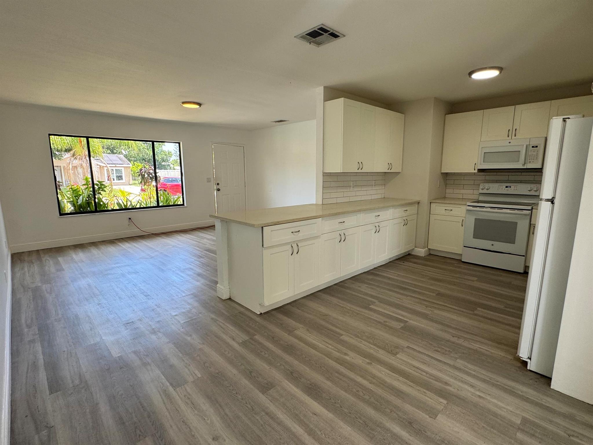 3 bedrooms, 1 bath, 1 car-garage home on Quiet Street, nicely updated and upgraded white cabinets, quartz countertops. Vinyl Flooring Throughout (no carpet). 2 full size refrigerators, washer and dryer in garage. Recently painted. Move-in ready.