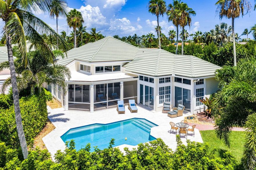 Experience unparalleled coastal living in this elegant residence, located in the exclusive Sailfish Point community. Your private retreat offers serene lake views and a stunning backdrop of the Jack Nicklaus ''Signature'' golf course.Inside, natural light pours through soaring ceilings and clerestory windows, illuminating the beautiful travertine marble floors. The sophisticated floor plan is perfect for both relaxation and entertaining, featuring 3 bedrooms, 4.5 baths, formal living and dining spaces, and a generous family room. The gourmet kitchen is complemented by a breakfast area, bar, a wet bar, and a wine cooler.The luxury extends outdoors to a screened patio and a sun-drenched pool area with travertine decking and refreshed landscaping. Complete with a new pool heater, impac