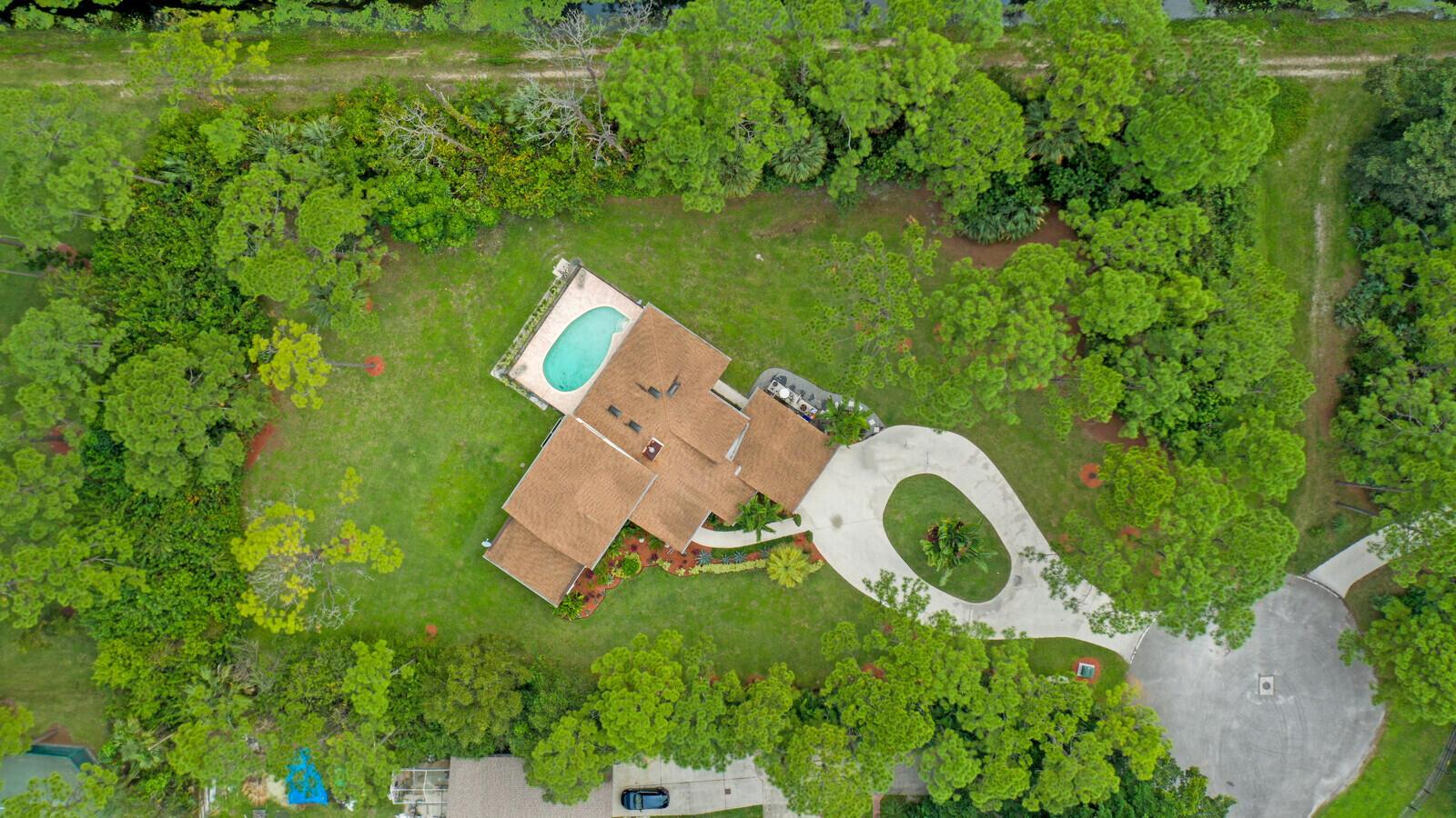 This beautiful CBS property custom built by the owners, offers 2734 living sqft, 3967 total sqft, 5 bedrooms, 2.5 baths, pool and 2 car garage. Step out and enjoy the nicely manicured 1.12 acres located on a private road nestled in the corner of a cul-de-sac. The kitchen is open and overlooks the oversized enclosed patio, pool and back yard. Jupiter Farms is a great place to raise your family with excellent schools, easy access to highways and just minutes away from the beaches. Bring your horses, pets, bicycles and motorcycles; There are plenty of trails to enjoy! Come and see why Jupiter Farms is one of the most sought after areas in Jupiter! All measurements are approximate.