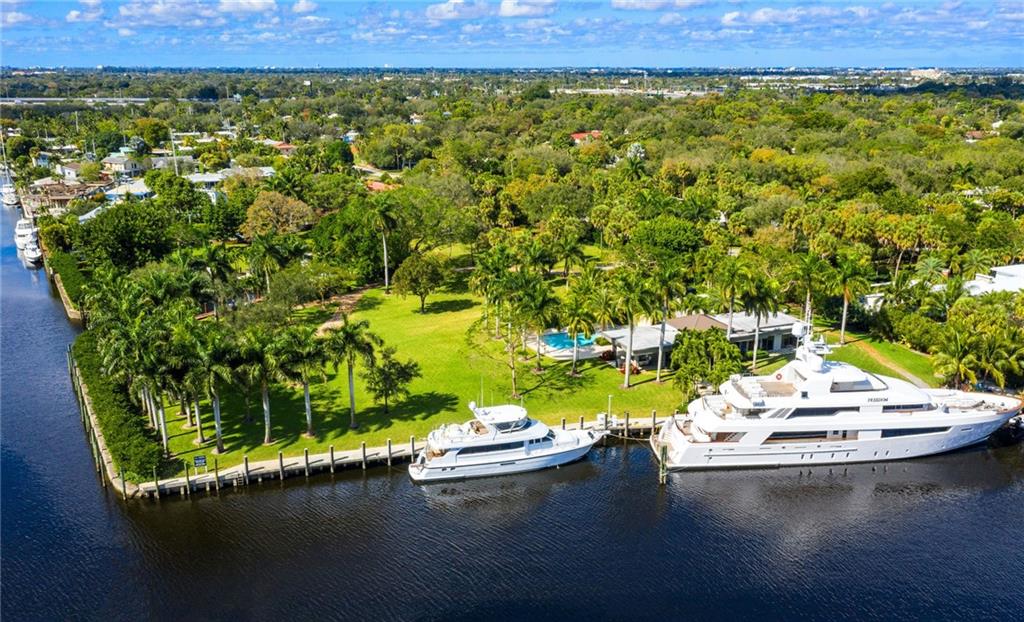 Dock Your Mega Yacht. Gated Waterfront Estate with 4.5 acres of land and 1103 feet of deep water dockage with one stretch of 300 ft which can handle the largest yacht. This spectacular property is Located on the New River in Fort Lauderdale. Possibly could be subdivided or just build one large estate. The owners home, built in 2018, is a 1 bedroom and 1.5 bath with a salt water pool and the finest finishes. Gazebo set in the center of the property to watch the parade of yachts go by. The most beautiful landscaping throughout makes you feel that you have stepped back in time with all of the beautiful trees and lighting. This could be one of the last largest pieces of property and deep water in Fort Lauderdale. If you want privacy this is it. Truly a must see.