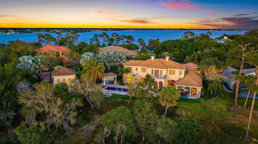 Welcome to 511 N.W. Winters Creek Rd located in the prestigious 24-hour guard gated community of Harbour Ridge in Palm City. This custom residence has been meticulously curated to meet the highest of standards. Entering through the gorgeous oversized double front doors you are immediately greeted by a soaring two-story foyer with chandelier, then your vision is drawn through the home's most distinctive architectural elements; Stunning pillars, grand floor-to-ceiling stone fireplace, then looking through 3 sets of French doors to view the exterior arched columns reminiscent of La Loggia del Mercato Nuovo in Florence Italy, framing panoramic views of the meticulously landscaped private grounds and pool area.