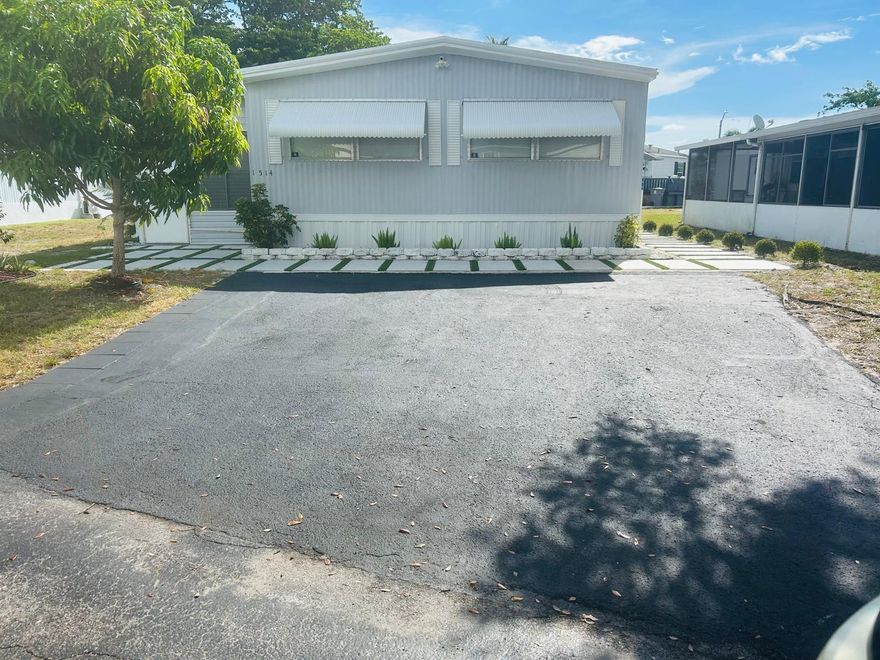 This beautifully updated home offers modern living with a brand-new gourmet kitchen featuring quartz countertops, sleek new appliances, and crisp white cabinetry. Both bathrooms have been tastefully renovated, and stylish tile flooring runs throughout the entire home. Enjoy attractive landscaping and a welcoming community atmosphere. The land is leased, with a monthly fee of $1,050 that covers lot rent, lawn care, water, sewer, and trash. Amenities include swimming pool, clubhouse, playground, tennis courts, basketball court, sand volleyball court, little league field and community laundromat. Nice location in Boynton Beach nearby lots of great places to eat and shop.