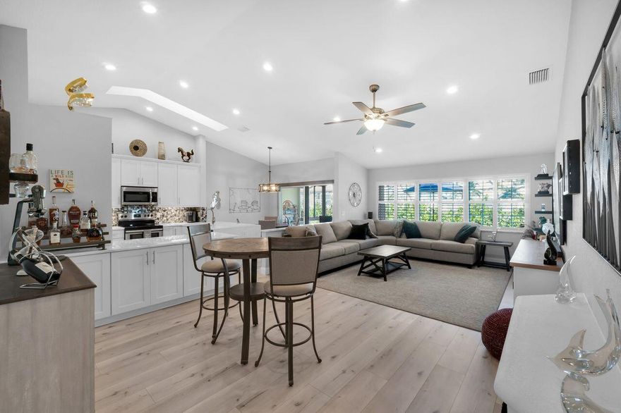 Stunning end-unit 2-bedroom, 2-bath villa featuring a spacious, open floorplan with vaulted ceilings and skylights. Beautifully remodeled and impeccably maintained, this residence showcases exceptional attention to detail, including custom-designed closets and plantation shutters throughout. A flexible den is ideal as a home office or easily converts to guest sleeping space. The sparkling eat-in kitchen offers abundant cabinetry. An all-season lanai opens to a marble-finished patio, creating seamless indoor-outdoor living. The immaculate, air-conditioned garage will delight any car enthusiast. An oversized driveway adds convenience. St. Tropez at Boca Country Club is ideally located just minutes from I-95, Mizner Park, downtown Boca Raton, and Delray Beach.