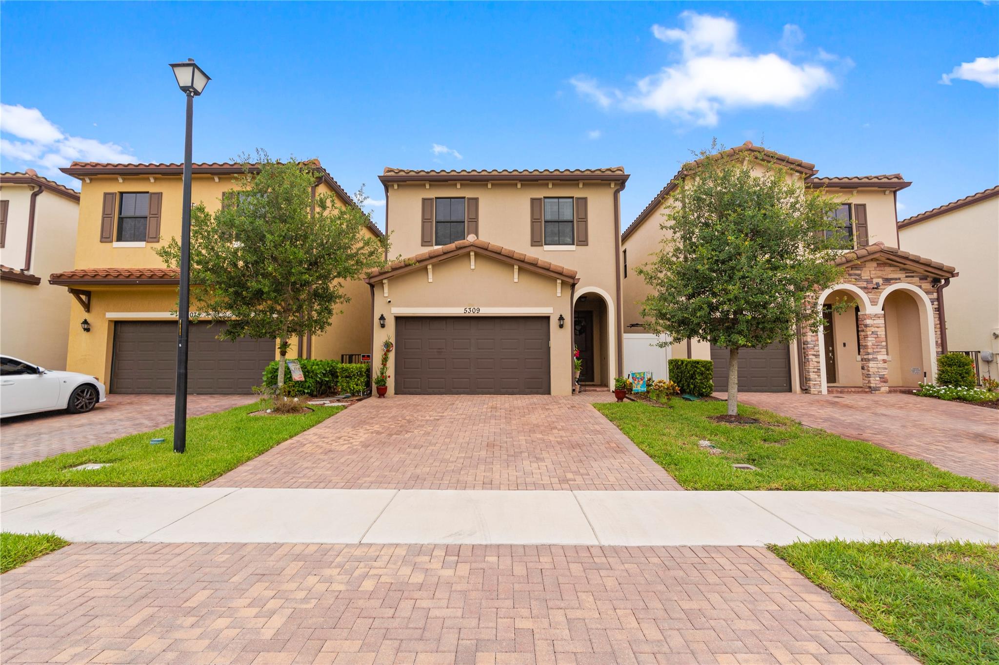 SERENE Home in sought-after community, Manor Parc. Built in 2019, it features RAIN-SOFT Water Purification System, Generac generator & PGT IMPACT windows & doors. Enjoy a FULLY screened-in patio with extended brick pavers, upgraded A/C with UV light & epoxy garage floors & other built-ins! The open layout offers a formal entry, spacious family room & eat-in kitchen with island, stainless steel appliances & solid wood cabinets. Located in quiet section with no rear neighbors or busy roads, & guest parking nearby. Community amenities include community pool, pool cabana with restrooms, BBQ area, playgrounds, sidewalks for walking trails and lush landscaping. Prime location near Turnpike, I-95, Sawgrass Mills, dining, and beaches. No HOA approval Required & VA Assumable loan at 4.625%