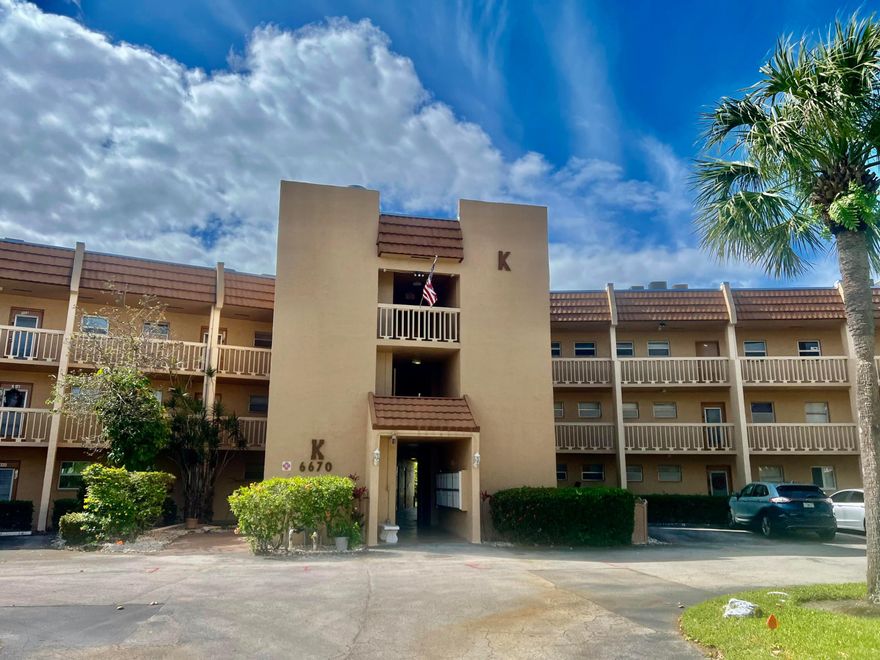 Enjoy life in this well-maintained 55+ community  of Royal Park Gardens.  Pride of ownership shows in every aspect of this well appointed condo.  Park directly in front of your ground floor unit.  This condo offers a unique kitchen and is well protected from any type of inclement weather. Hurricane shutters on all windows, plus hurricane impact windows in the living room and patio.  The patio is enclosed for all weather use and is used as an additional room.   Kitchen snack bar has additional storage space.  Large tile throughout.  Amenities include pools,  tennis, pickleball, and bocce.  Laundry room and storage areas on the first floor are close to the unit.  Building has its own party and exercise rooms.