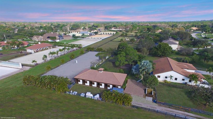 This Paddock Park 2 property has it all! The stunning 4 bedroom + den, 3 bath home has beautiful wood & travertine flooring throughout, volume ceilings, state of the art kitchen and so much more. The 6-stall center aisle barn has tack & feed rooms and a 1 bedroom, 1 bath grooms apartment. Property also has a riding arena and 6 paddocks.