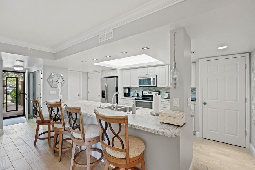 This renovated first-floor condo offers luxurious upgrades throughout. The kitchen is redesigned to open seamlessly into the dining and living areas. It includes a full-size washer and dryer. The guest bedroom has two twin beds, while the master features a king bed with upscale bedding, a remodeled bathroom, and a walk-in closet. Enjoy the screened-in balcony with outdoor seating and landscaping just steps from the pool. The community offers pools, a hot tub, a fitness center, tennis courts, and walking paths. Walking distance to the new Whole Foods Plaza and 1 mile to both downtown and the beach.