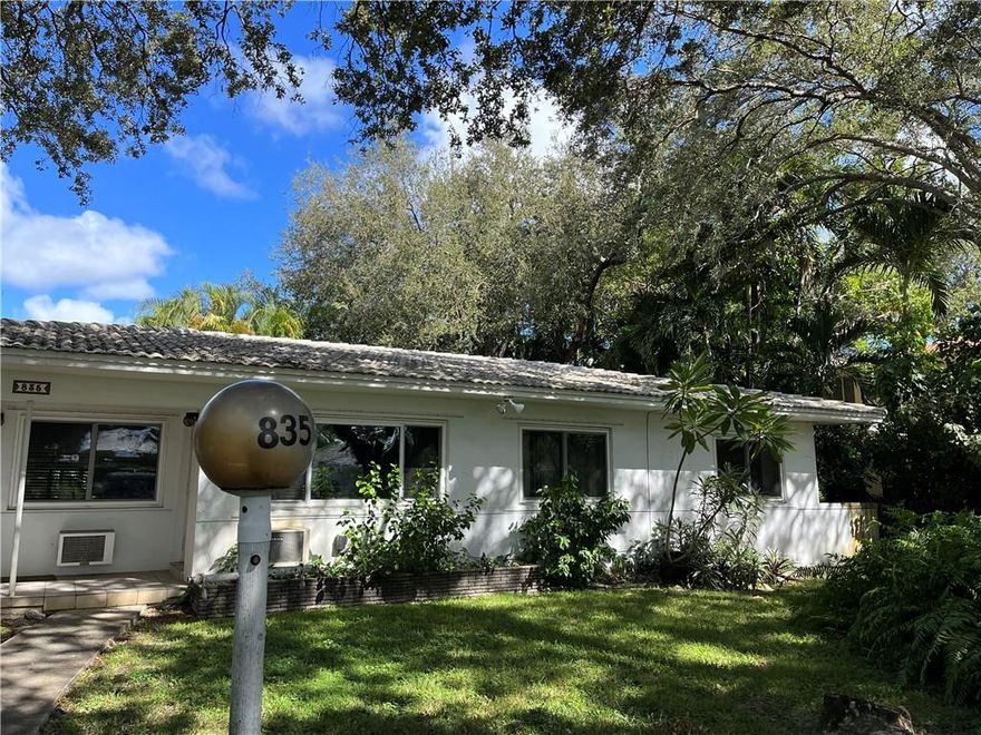 This beautiful mid century home was originally a 1/1 and a 2/2 Duplex (2 kitchens) and was opened up by the current owners into a 3/3, cooled by one large central AC unit.  The home features ceramic tile throughout, and lots of original features remain.  The house is located on a beautiful park like street with mature tree canopy and extra wide median, in desirable Biscayne Park, within walking distance to park and the town hall. The 2 car garage is located of an unpaved alley in the back and features a loft apartment with full bath (kitchen was removed because Biscayne Park only allows 2 kitchens on a property).  The possibilities are endless here to divide back to smaller duplex or spread out over the entire property.