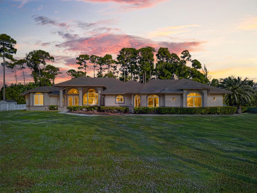 This impressive Majestic Homes White House model sits on over one acre of high, dry land in the sought-after Acreage community, where horses and outdoor living are welcome. The home features a rare, fully independent in-law suite with a private entrance and optional interior access--ideal for multigenerational living or guests. Enjoy a resort-style pool, expansive patio, outdoor kitchen, and convenient cabana bath, perfect for entertaining. Located just minutes from Northlake Blvd, this property offers the privacy of rural living with easy access to shopping, schools, and major conveniences.