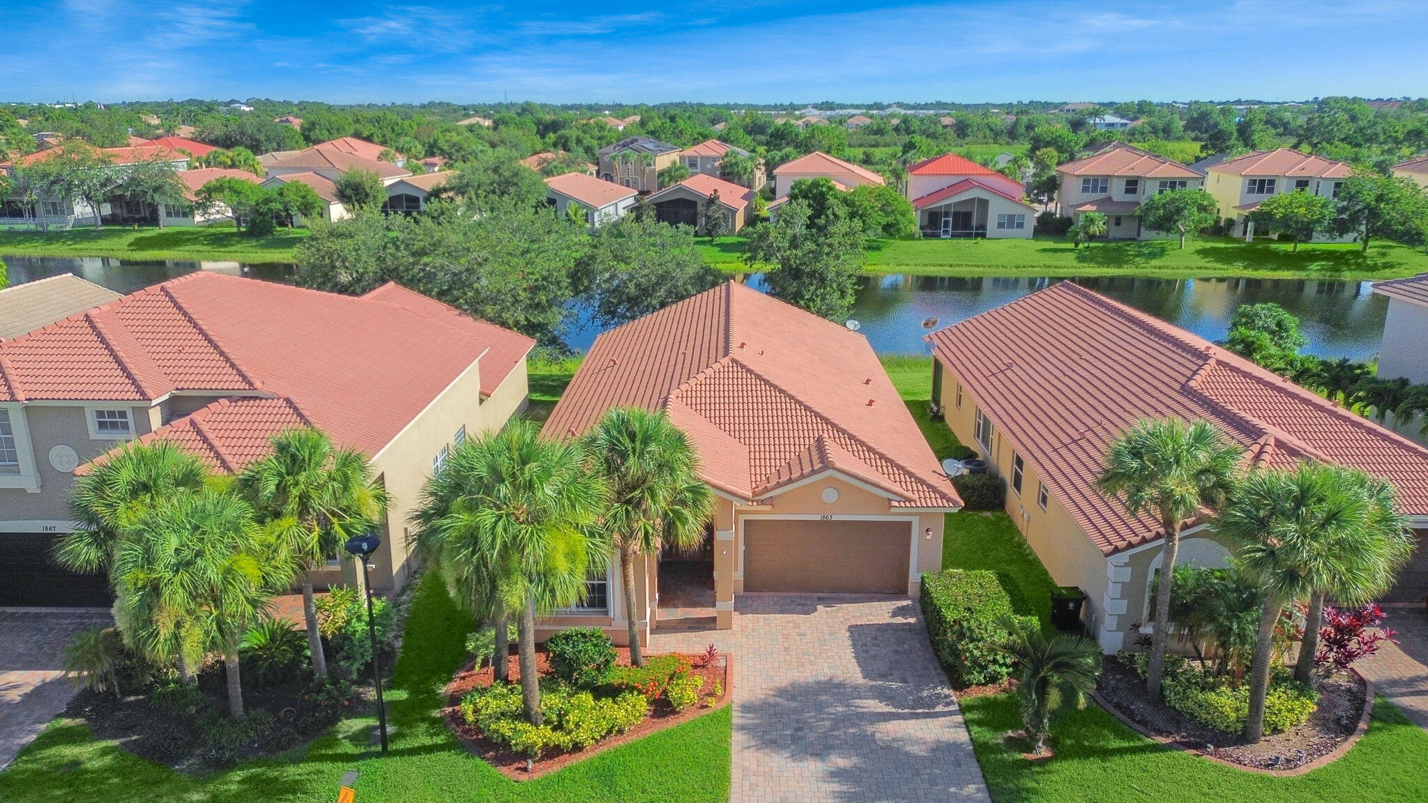 Beautiful 3br, 2ba LAKEVIEW HOME located in the upscale gated community of Newport Isles. Tile flooring throughout and wood-look vinyl plank in bedrooms, (NO CARPETING). Open gourmet kitchen with center island, 42' cabinets and stainless steel appliances. The home's spacious layout includes formal living and dining areas, plus a cozy family room perfect for relaxing or entertaining. Enjoy the outdoor Florida lifestyle on your covered and screened rear patio with stunning lake views. ACCORDION HURRICANE SHUTTERS. Rent includes free internet, lawn care & access to Newport Isles resort style amenities, such as clubhouse, pool, gym and more. Close to Tradition without the Tradition price. Take a short drive and enjoy Tradition's wonderful shopping, dining and entertainment. Close to I-95 & Cl