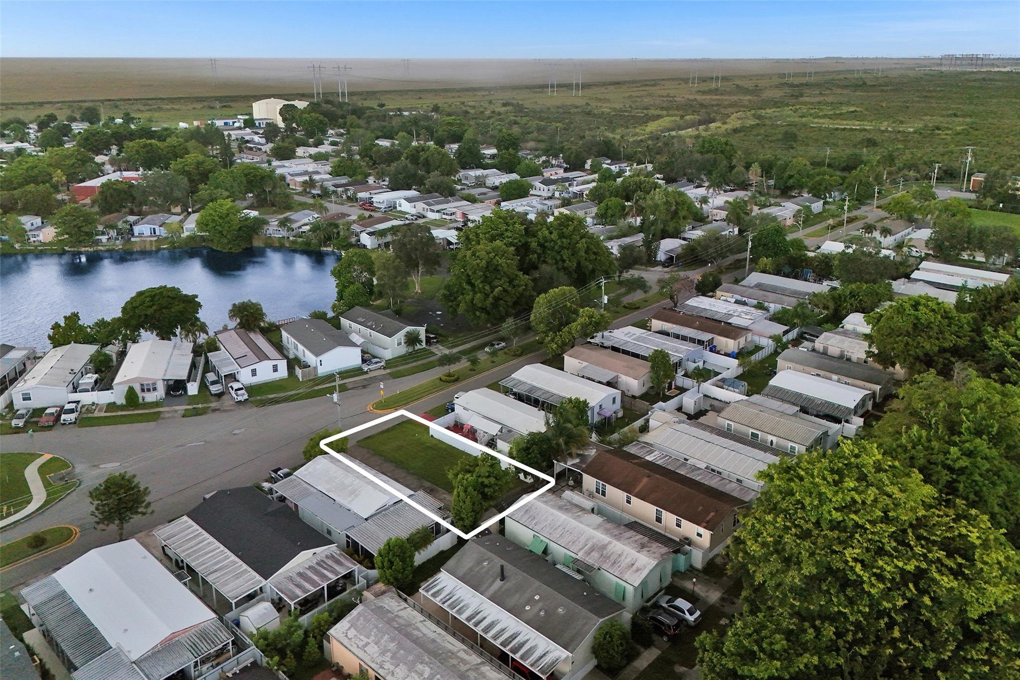 Looking for the perfect spot to place your mobile home? Look no further! This vacant lot in Pembroke Pines offers more than just a space; it gives you a whole community to enjoy, along with the incredible benefit of owning the land. This is a true rarity for manufactured home parks and a valuable long-term investment. Low HOA, NO RENT RESTRICTIONS! The community offers a recreation building, gym, basketball and racquetball court, and 2 pools. Minutes from shopping centers and highways.