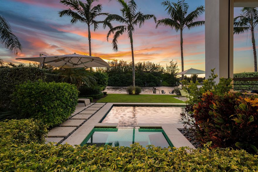 Discover a masterfully designed townhome that perfectly combines modern aesthetics with impeccable craftsmanship. Built by the esteemed National Custom Homes, this residence stands as a testament to superior quality and innovative design. Nestled in a prime location, the townhome boasts an unobstructed direct intracoastal view, offering an awe-inspiring vista that stretches beyond the horizon. With 40 feet of frontage, the property graciously accommodates a 36-foot boat, providing an exceptional opportunity for maritime enthusiasts.

Situated opposite a natural preserve, relish in the tranquility and be captivated by the beauty of endless sunsets that grace the horizon. Upon entering, you are welcomed by the grandeur of  12-foot+/- ceilings that sweep across the main living areas. Floor-to-ceiling glass panels seamlessly merge the indoors and outdoors, allowing the breathtaking surroundings to become an integral part of your living experience.

Luxury wood-like tile graces the floors, lending an air of sophistication to the interiors. The integration of cutting-edge technology enhances the home's allure, with full smart home capabilities seamlessly controlled by systems such as Control4 and Sonos. Phantom screens and electric shades offer both convenience and ambiance, ensuring a harmonious blend of comfort and style.

The townhome comprises four spacious bedrooms, three up and one downstairs. Each boasting meticulously designed built-in closets and en-suite bathrooms. These private retreats offer a blend of elegance and functionality, catering to your every need.

Ascend via the elevator to the VIP bedroom, a secluded enclave complete with an en-suite bathroom. Step onto the private balcony that presents sweeping views of the intracoastal waters, a personal sanctuary for moments of quiet reflection and rejuvenation.

For those who relish in outdoor living, the covered loggia beckons. This inviting space is perfectly suited for alfresco dining and entertaining, creating cherished memories with friends and loved ones.

Stepping into the backyard, you'll be greeted by a haven of leisure and relaxation. The private pool, complete with a soothing waterfall feature, becomes a focal point of serenity. The travertine deck exudes elegance while providing a perfect platform for sunbathing and socializing. A fully equipped, built-in summer kitchen caters to your culinary desires, making outdoor gatherings a delightful experience.

Boating enthusiasts will find delight in the 39-foot private dock, a mere 10-minute boat ride away from the Boca Inlet. This offers not just a practical convenience, but a gateway to endless aquatic adventures.

In summary, this modern contemporary townhome harmoniously blends exquisite design, technological sophistication, and natural beauty. It presents a unique opportunity to live life to the fullest, surrounded by elegance and comfort. Experience the allure of waterfront living and embrace a lifestyle that encapsulates luxury, convenience, and natural splendor.