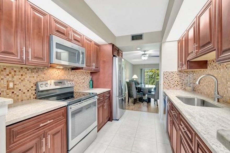 Modern 2bd/2bath Juniper floor plan. Featuring 2 walk-in closets. This beautifully updated condo features: New AC(DEC-25), In Unit washer/dryer, Remodeled kitchen with wood soft close cabinets, 1” thick granite countertops, newer SS appliances, bathrooms have same cabinets/granite as kitchen, lvp flooring in living/dining area, led lighting thruout, freshly painted, plush carpet bedrooms, and newer patio screening. Mr. Clean lives here. Including Fully Furnished! Best location in Wynmoor. Walk to main pool, fitness center,BBQ party center, and theater.