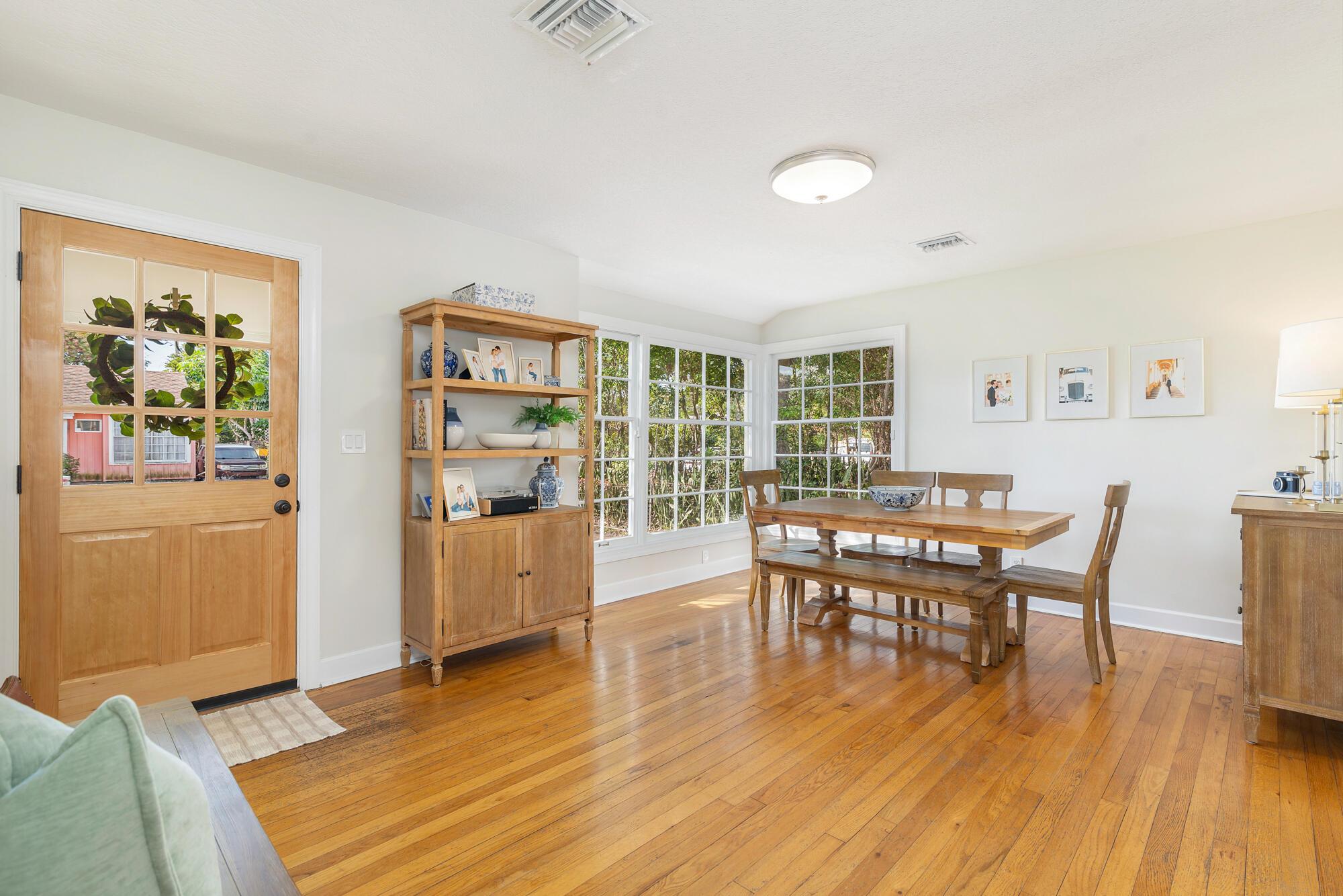 Old Florida charm abounds at this 1940s Key West cottage that is available for lease this upcoming season. Fully furnished and appointed, this home is ready for seasonal tenants to enjoy life in the Southend of West Palm Beach. The home exudes the storybook style of a bygone era but has all the updates for modern living. Located in the South of Southern neighborhood (nicknamed ''SoSo''), this home boasts the historic details people love - including the original hardwood floors throughout the living area and bedrooms. Natural light floods the living room from large windows. Freshly updated kitchen with white cabinetry, granite countertops, a glazed subway tile backsplash, stainless steel appliances and an eat-in breakfast bar with a convenient pass-through to the family room.