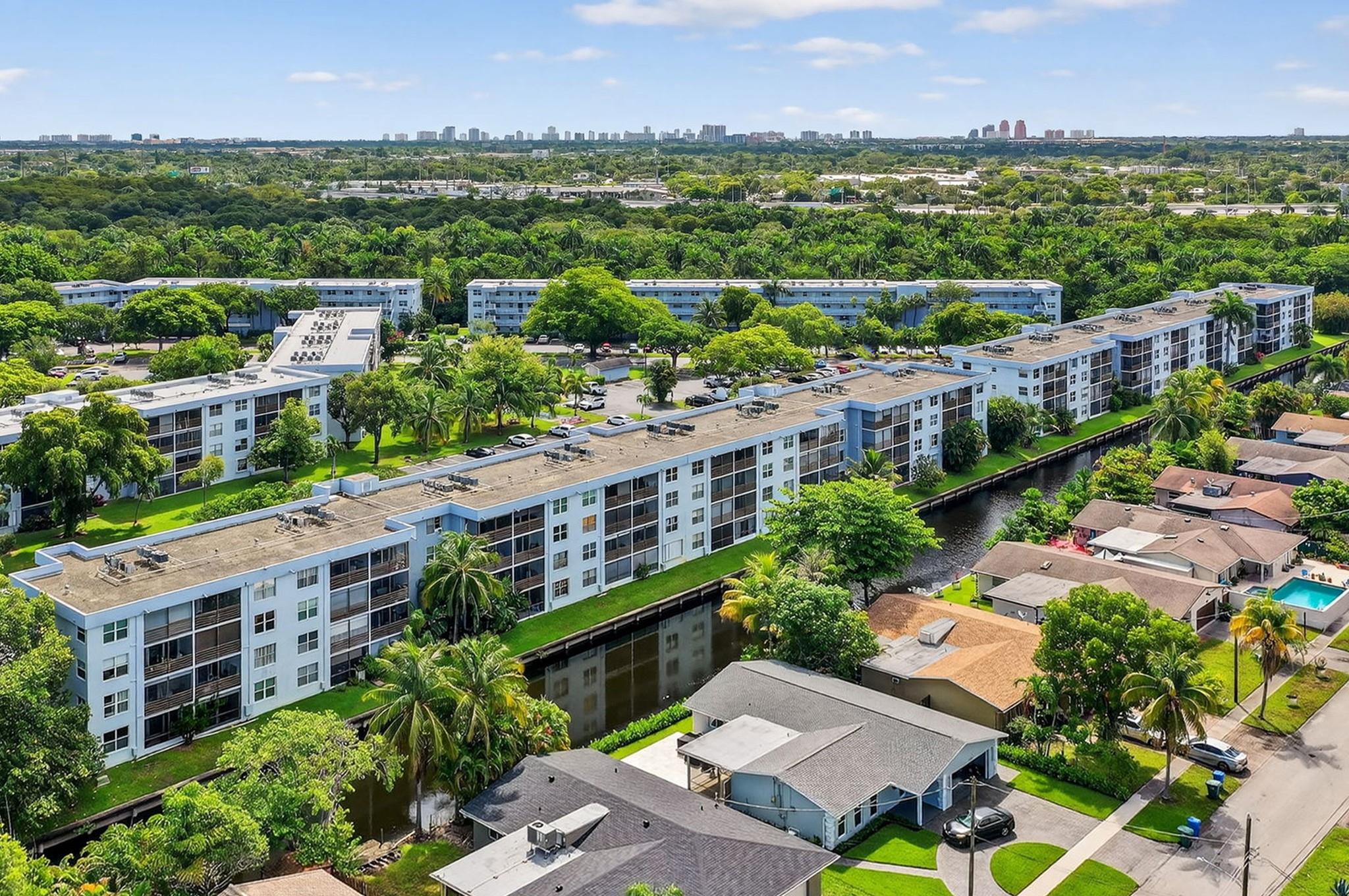 In the gated community of Royal Park is this WATERFRONT second floor 2 bdm, 2 bth condo featuring a nicely updated U-shaped kitchen with cherry mahogany cabinetry and handsome granite counters. From the expansive living/dining area, enjoy the relaxing WATERFRONT CANAL VIEW, or step out to your private balcony and immerse yourself in peaceful tranquility. Both primary and 2nd bdrm offer walk-in closets and ensuite baths. | IMPACT WINDOWS & SLIDER | CHERRYWOOD LAMINATE FLOORS | TANKLESS WATER HEATER | 3 heated pools, clubhouse, gym, sauna, carwash, laundry, 24-HR GUARD GATE, and… PET FRIENDLY | Enjoy nearby Royal Park's playground, sand volleyball, basketball, tennis & pickleball courts, Stunson Nature Trail, Easterlin Park & Bark Park. Super convenient to Wilton Manors, Downtown FTL & I95.