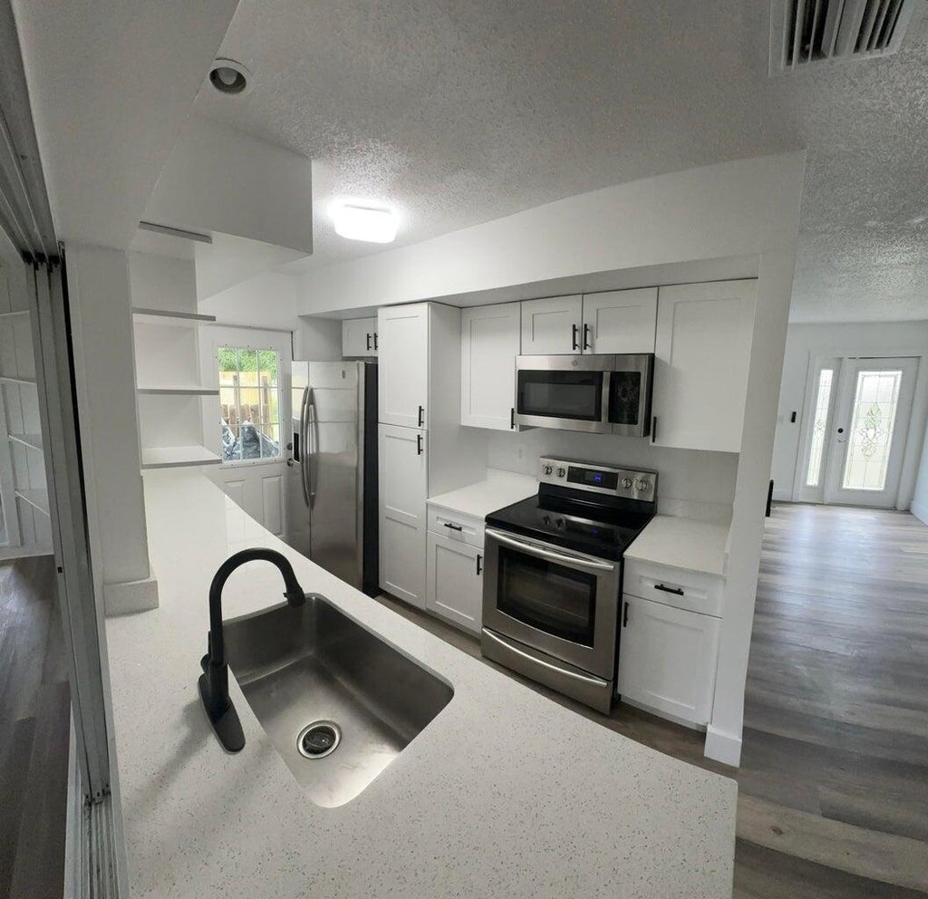 Photo of 402 NE Armony Circle, Port Saint Lucie, FL 34983 (MLS # R11040110)