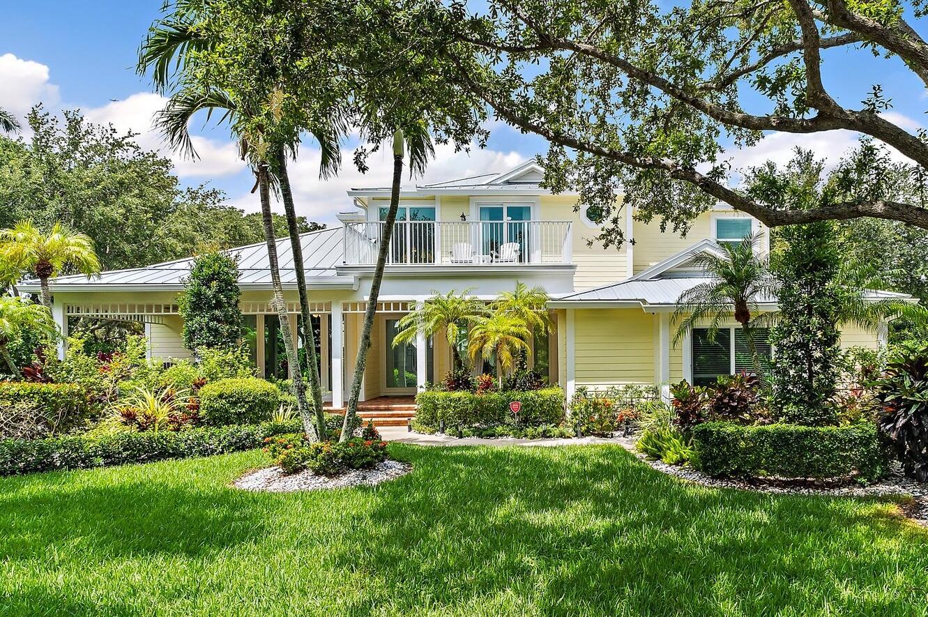 Total professional renovation, move-in ready, concrete block Key West style. two-story home on oversized half acre lush private lot. Recent renovations include: new metal roof, impact windows, $20k pivot front door, porcelain tile floors, Thermador and Fulgor Milano kitchen appliances, all new bathrooms, two a/c, pool equipment and diamond brite, custom professional decorations, extensive $50k landscaping for privacy. Master bedroom downstairs plus private office, two guest bathrooms, and laundry. Three bedrooms and two bathrooms upstairs, and a private outdoor patio. The tree lined streets of Sewalls Meadow create a peaceful environment with sea breezes.