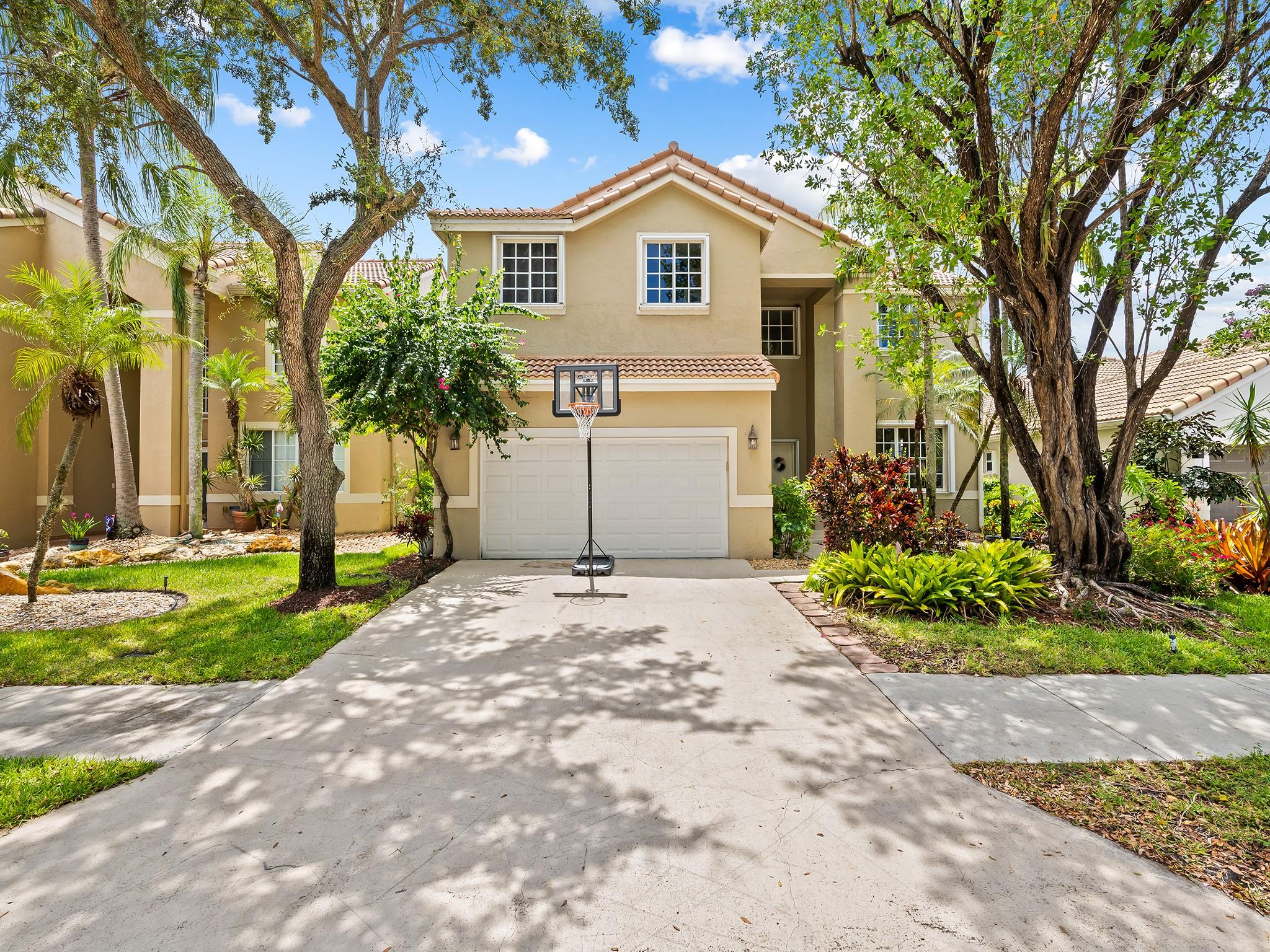Nestled in the family favorite Lakes of Weston, this 5/4, large 3117 square foot waterfront home with new roof (4yrs old), impact doors, windows and accordion shutters has been lovingly and meticulously cared for and updated. Beginning with double high foyer, welcoming living and dining areas which flow into a kitchen that overlooks the family room, with water views of the lakefront, this is all completed with an illuminated fountain for your sight and sounds. Versatile floor plan features an expansive Master-suite with a lake view, incl a smartly remodeled master bathroom and an additional en-suite bedroom that could easily function as a second master. All this with three more generously sized bedrooms, this residence offers a wealth of living options to suit any family's needs.