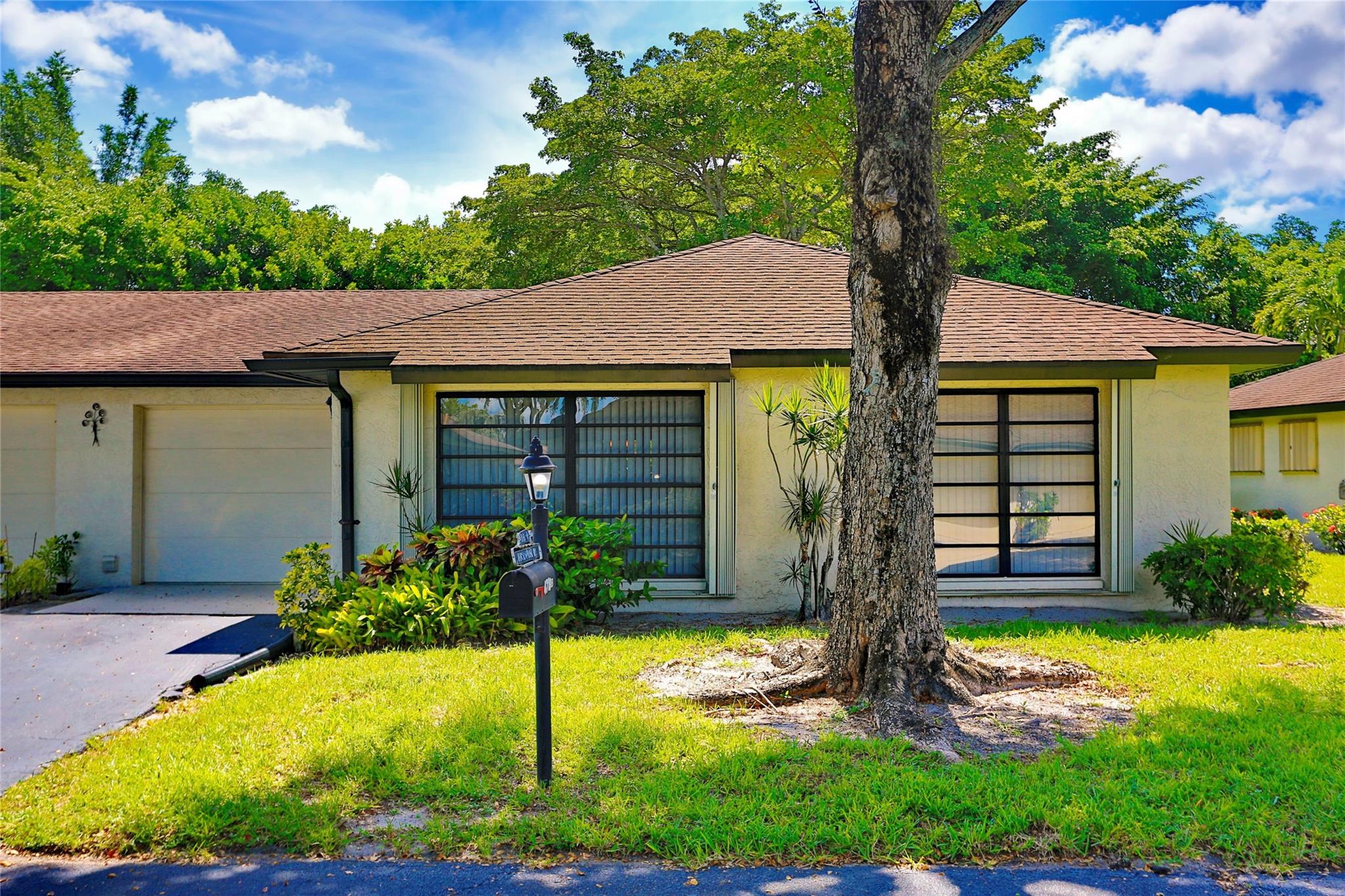 Welcome home! The perfect place for single folks or couples, future or current retirees, downsizers, snowbirds and anyone 55 and older. This beautifully maintained 2BR/2BA villa with a 1-car garage is nestled in the sought-after peaceful community of Greentree in Boynton Beach. The updated kitchen boasts granite countertops, stainless steel appliances, and a cozy island with seating for four. Washer and dryer located in garage. Fabulous Florida room with access to back area, the perfect place to bring your BBQ grill. Home equipped with gutters and hurricane accordion shutters. Clubhouse, 6 community pools and condo association offers cable, internet, and water. It's a great deal for $580 per month. Located near shopping, hospitals, restaurants and major roadways.